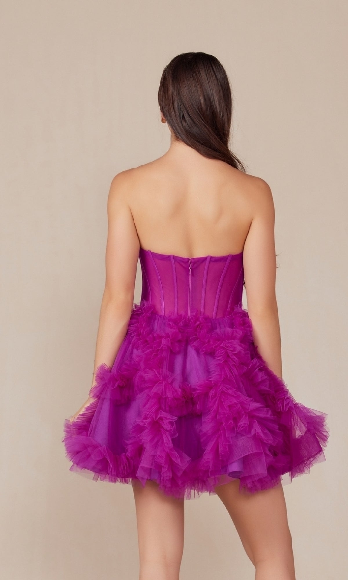 A woman with long brown hair stands with her back to the camera, wearing the Short Strapless Ruffled Homecoming Dress Y859—a magenta, strapless, a-line dress perfect for parties or homecoming.